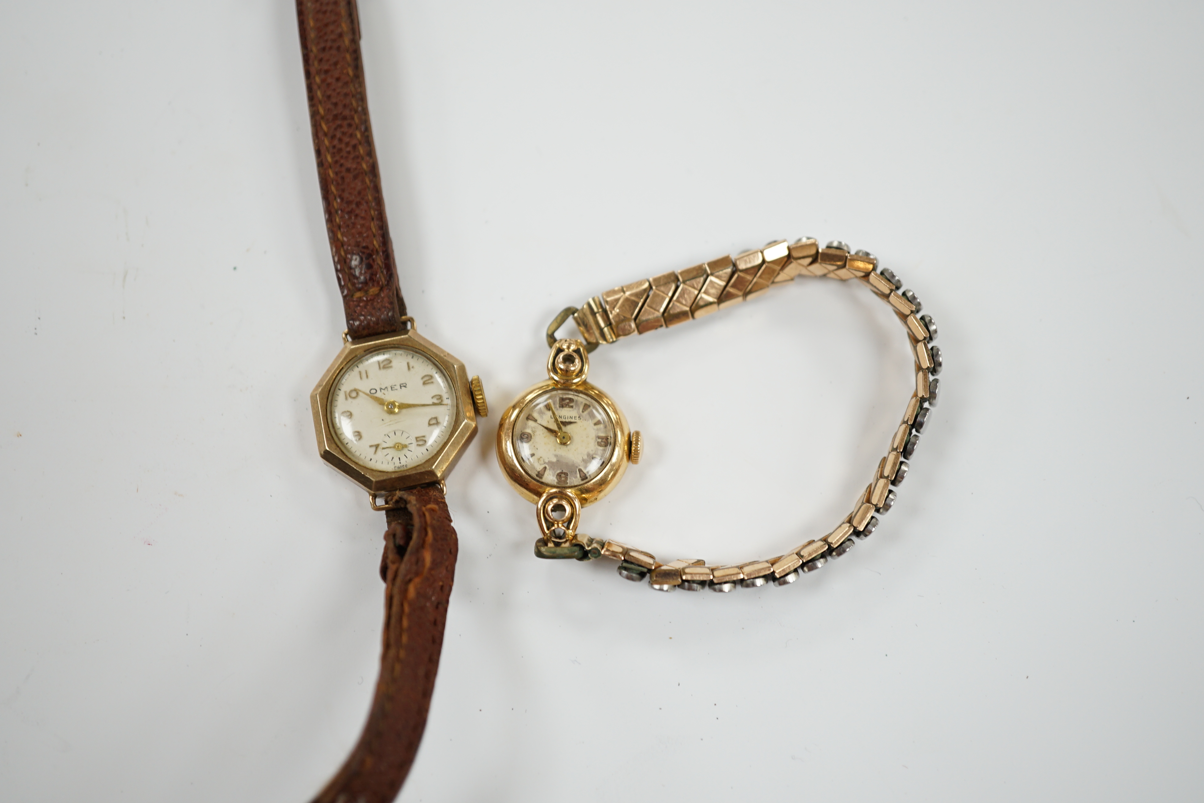 A lady's 18k Longines manual wind wrist watch, on a gold plated flexible bracelet, together with a lady's 9ct gold Omer manual wind wrist watch, on a leather strap.